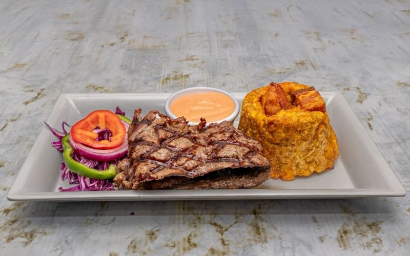 Discover the best-kept secret in Lawrence, Massachusetts—artisan Mofongo and grilled churrasco that redefine comfort food, topped off with a garlic sauce that’s simply irresistible!