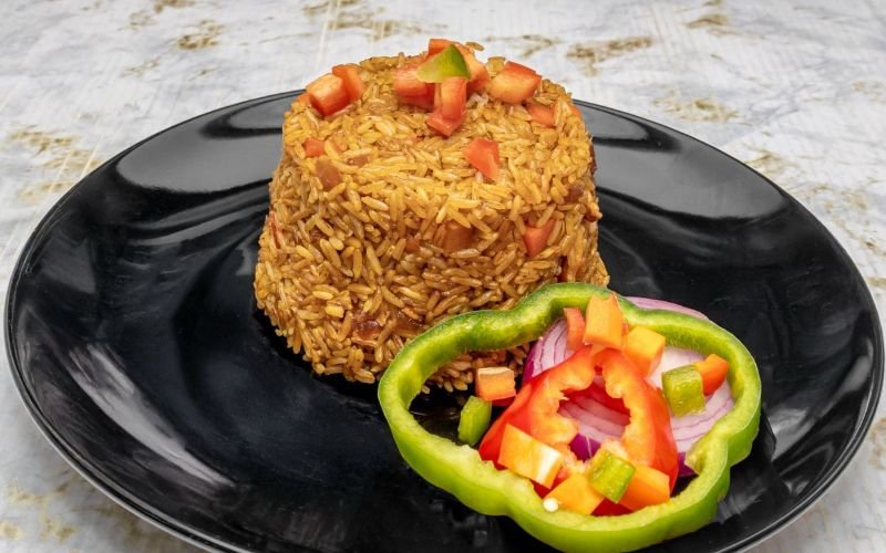 Delicious fried Rice with chicken, pork and bacon with a green salad. authentic Dominican and Latin cuisine in Lawrence