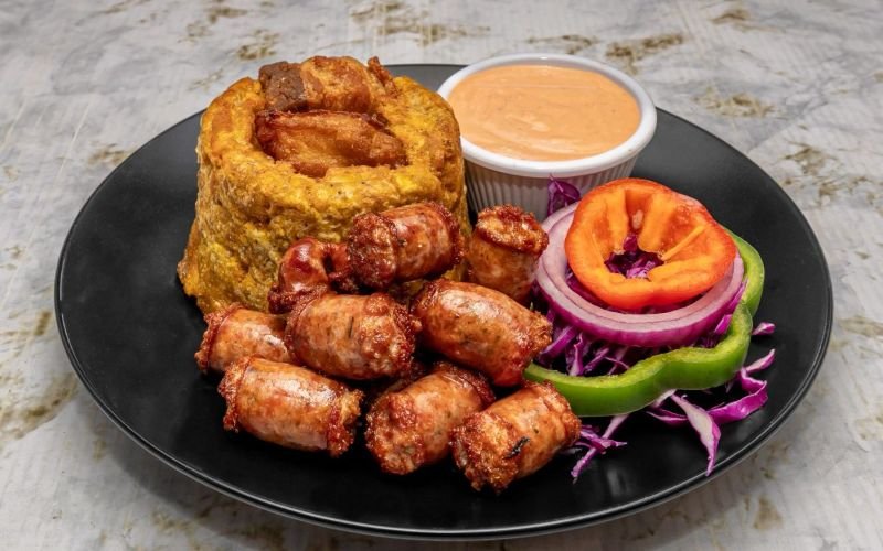 Dive into a culinary adventure with our mouthwatering Mofongo, perfectly paired with homemade longaniza and a garlic sauce that will have your taste buds dancing! Order online now and experience the best Dominican cuisine in Lawrence, Massachusetts!